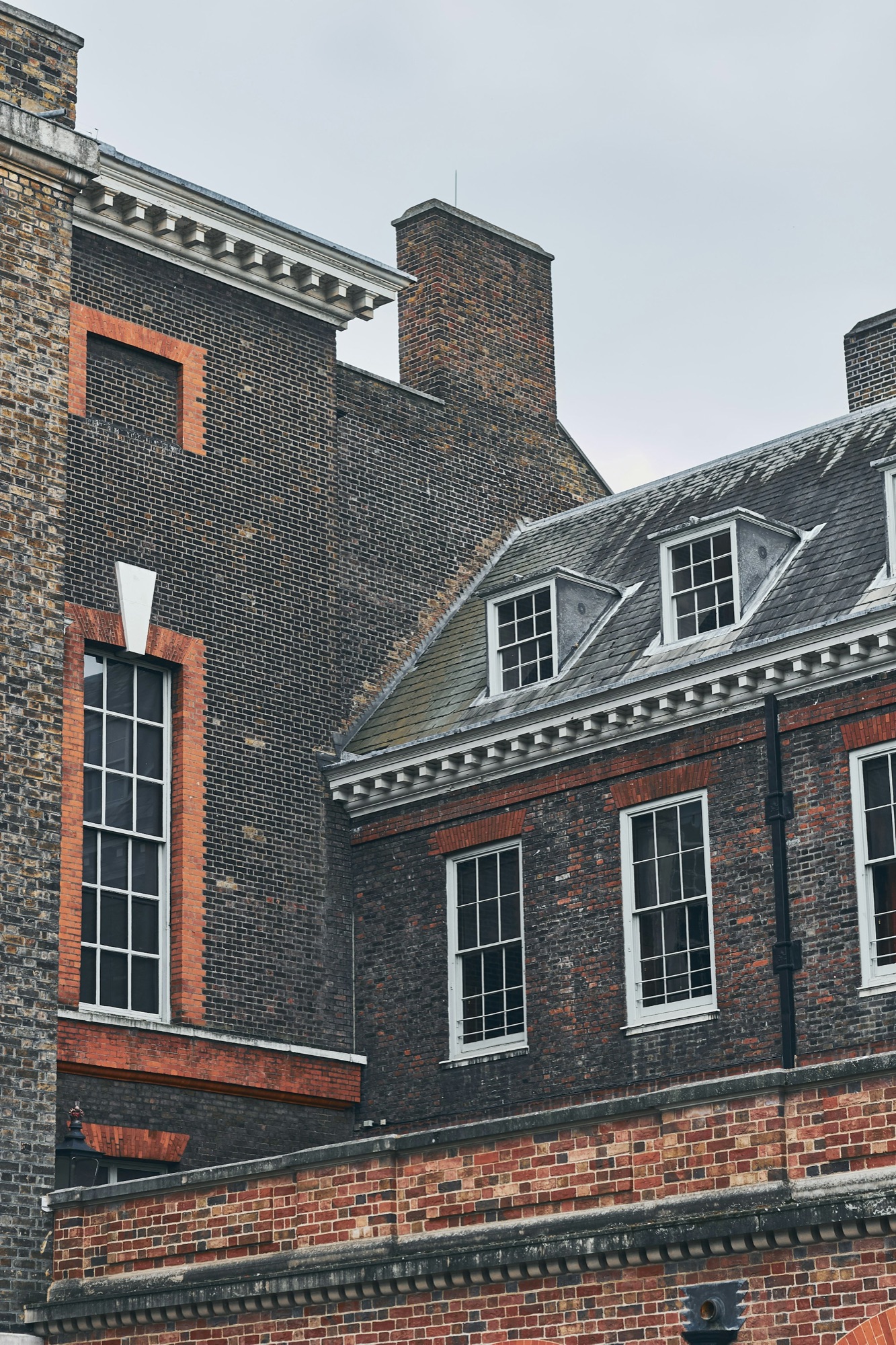 Period London roof with dormer windows and brick chimneys