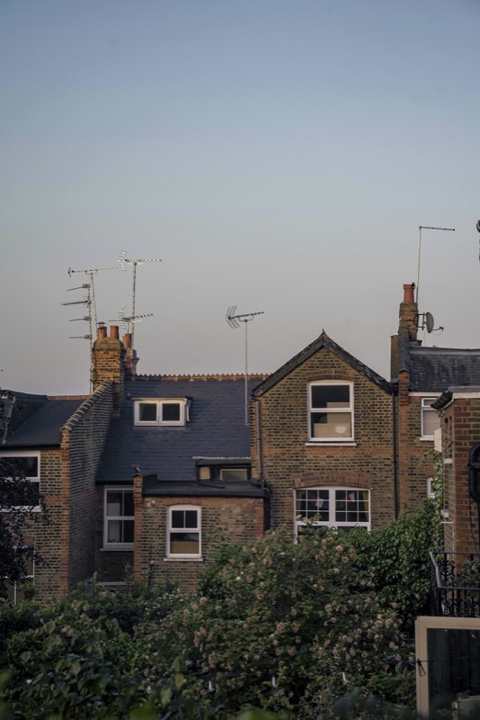 London slate roofline with dormer windows at dusk