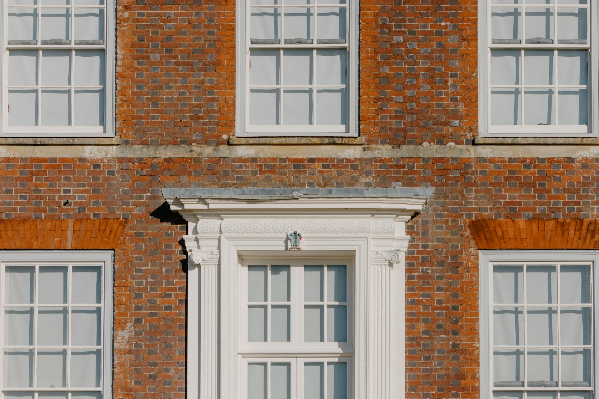 Georgian red-brick facade with sash windows and doorcase